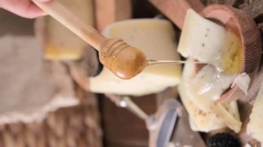 Pecorino cheese with truffle, traditional Italian sheeps milk cheese with truffle. A typical product of the dairy regions of Tuscany and Sardinia. Honey and cheese. High quality HD video. Vertical