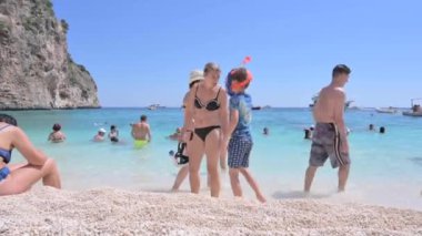 People on the beach in Sardinia. Clear clear water and blue sky. white beach italy. High quality FullHD footage