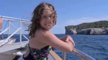 Yacht trip. A teenage girl with flowing hair on a yacht. Travel and tourism at sea. Happy emotions. High quality FullHD footage