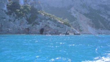 Small boat in the sea of sardinia. Luxury vacation. Embankment of Italy. travel on the waves. High quality 4k footage