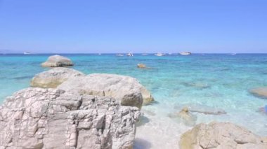 Blue beach in Sardinia. Italian coast, elite resorts. BLUE SKY AND CLEAR WATER and white small stones. High quality 4k footage. Vertical