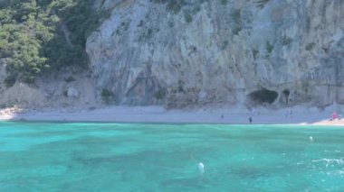 Small boat in the sea of sardinia. Luxury vacation. Embankment of Italy. travel on the waves. High quality 4k footage