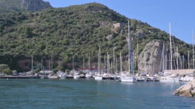 Small boat in the sea of sardinia. Luxury vacation. Embankment of Italy. travel on the waves. High quality 4k footage