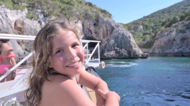 Yacht trip. A teenage girl with flowing hair on a yacht. Travel and tourism at sea. Happy emotions. High quality FullHD footage