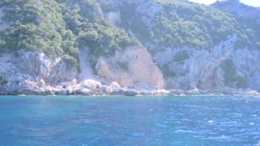 Small boat in the sea of sardinia. Luxury vacation. Embankment of Italy. travel on the waves. High quality 4k footage