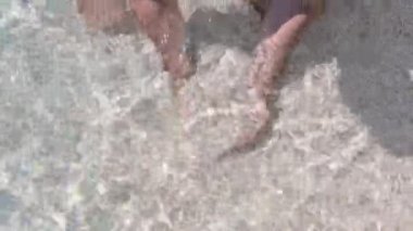 White pebbles in the hands on the beach of Sardinia. Italian white beach. High quality 4k footage