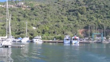 Small boat in the sea of sardinia. Luxury vacation. Embankment of Italy. travel on the waves. High quality 4k footage