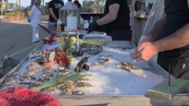 Seafood in a restaurant. Fresh fish and shells are cooked. Open air restaurant by the sea. High quality 4k footage