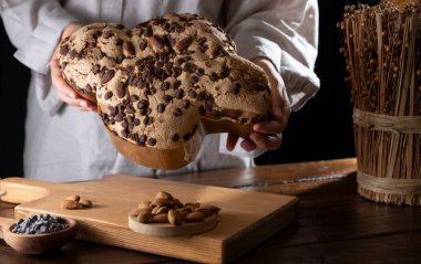 Colomba with chocolate. Easter Italian cake with almonds and chocolate in the shape of a dove. Festive pastries are traditional in Italy. 