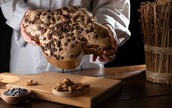 Colomba with chocolate. Easter Italian cake with almonds and chocolate in the shape of a dove. Festive pastries are traditional in Italy.