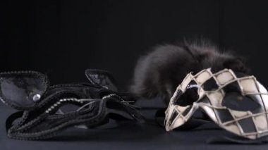 The symbol of the Venetian carnival is a plaid mask like a harlequin. Masquerade carnival in italy. Little black kitten and carnival mask. 4k . 