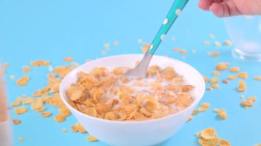 Corn flakes and milk. Sweet dry breakfast on a bright background. baby food. High quality FullHD footage