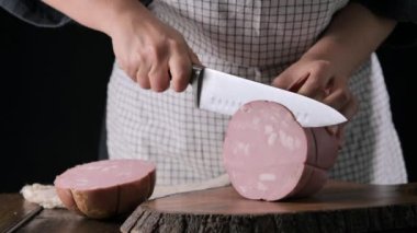 Mortadella. Traditional pork sausage with pistachios or black pepper. Italian delicacy from Bologna. High quality 4k footage