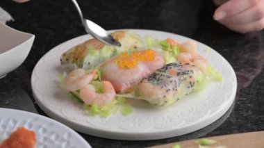 Pirinç kağıdında börek, hazırlık. Havyarlı, karidesli, pirinç kağıtlı güzel dolgulu bir böreğin yakın çekimi. Yüksek kalite 4k görüntü