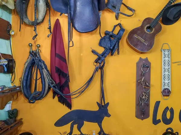 stock image Variety of gaucho culture objects hanging at wall of route restaurant, chubut province, argentina