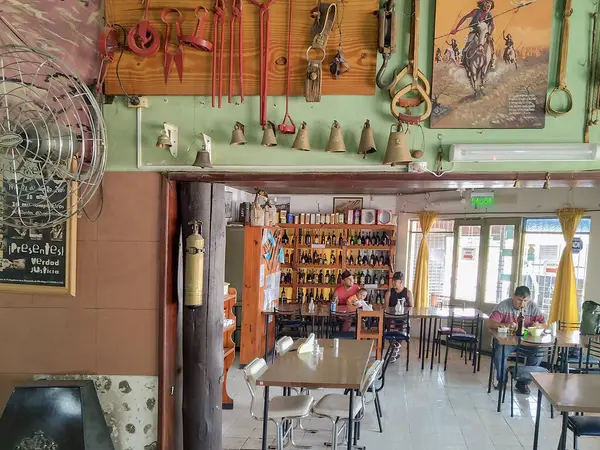 stock image Chubut, Argentina; December 30 2022: Variety of gaucho lifestyle objects hanging at wall of route restaurant, chubut province, argentina