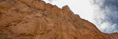 Low angle view rocky mountains formation landscape formed by ancient volcanic activity at piedra parada, languineo department, chubut province, argentina  clipart