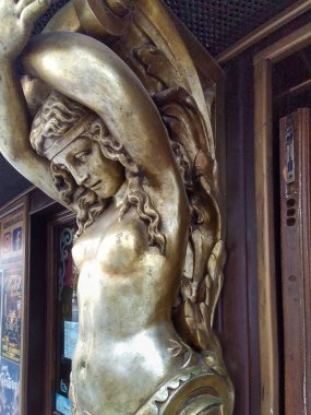 Kadın heykelinin mitolojik altın heykelinin orta açı görüntüsü.