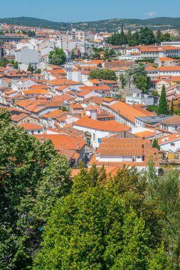Braganca şehrinin yüksek açılı manzaralı terracotta çatıları ve ağaçlarla çevrili yoğun kentsel yerleşim.