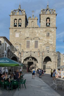 Braga, Portugal: August 14 2023: A charming cobblestone street in the historic center of Braga, Portugal, leading towards a beautiful baroque church. .