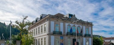 Vila Pouca do Aguiar, Portugal: August 14 2023: A shot of a large, classic historic building in a square in Vila Pouca de Aguiar, Portugal. 