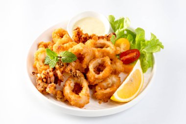 Kızarmış Calamari: Baharatlı hamurla kaplanmış yumuşak kalamar halkaları, çıtır çıtır kızartmak için kızartılmış, soslu marinara veya aioli ile servis ediliyor..