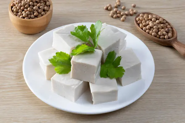Taze dilimlenmiş beyaz tabakta soya fasulyesi soya peyniri.