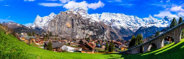 Switzerland nature and travel. Scenic traditional village Murren surrounded by snow peaks of Alps mountains. Popular tourist destination and ski resort