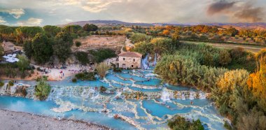 Most famous natural thermal hot spings pools in Tuscany - scenic Terme di Mulino vecchio ( Thermals of Old Windmill) in Grosseto province. high angle drone shoot clipart