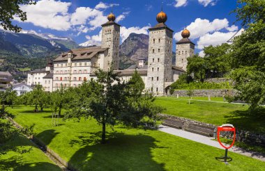 Switzerland travel and landmarks. Valais canton, Brig town.  Impressive Stockalper castle with beautiful garden and park clipart