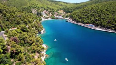  Yunanistan. Poradlar. Agnontas plajı ve turkuaz kristal denizi yeşil tepelerle çevrili küçük bir liman. Hava Aracı 4k hd video