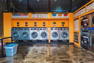 CHACHOENGSAO,THAILAND-JANUARY 3,2021 : View of laundry service shop with automatic washer dryer is available to general customers 24 hours a day at Maroom loundry shop. Cloth cleaning business concept