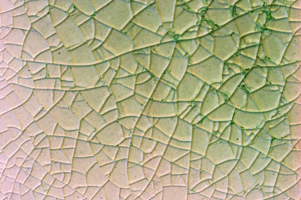 Close up to background and texture of stretch marks cracked on emerald green glazed tile. Scratches background. Vintage scratched grunge tile broken screen texture. Scratched glass surface wallpaper.