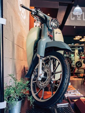 NAKHON PATHOM,THAILAND-JANUARY 7, 2023 : View of Honda Super Cub C 125 Motorcycle classic 125cc. collection on display for sale at CUB House Nakhon Pathom Honda x Greyhound Coffee. Concept retro.