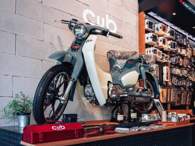 NAKHON PATHOM,THAILAND-JANUARY 7, 2023 : View of Honda Super Cub C 125 Motorcycle classic 125cc. collection on display for sale at CUB House Nakhon Pathom Honda x Greyhound Coffee. Concept retro.