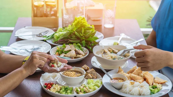 Enjoy eat with Vietnamese Meatball Wraps (Nam-Neung), Pork Sausage wraps with fresh vegetables in rice paper, generous platter eat with sweet sauce. Vietnamese Pork Sausage and salad. Selective focus.