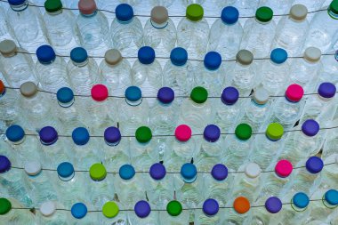Beautiful wall made of multi colored recycled plastic bottles