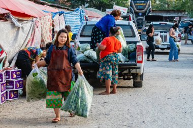TAK, THAILAND-ARALIK 13. 2020: Etnik tedarikçiler kamyondan çeşitli sebze torbaları boşaltıyor, tedarikçiler yerel halka Muser Hill Kabile Pazarı 'nda taze ve ucuz ürünler sağlıyor.