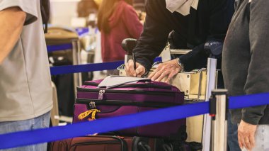Havaalanında kalem doldurma formu kullanan bir adam. Göçmenlik formunu dolduran bir erkek turist. Erkek yolcu göçmenlik kartı yazıyor. Bir adam kağıt imzalıyor, yazıyor..