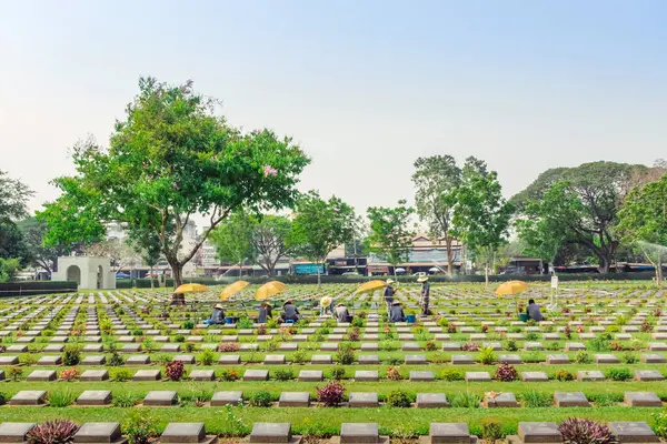 stock image KANCHANABURI THAILAND - FEBRUARY 21 : Unidentified Workers renovate and decorate flowers at Kanchanaburi Allied War Cemetery on February 21,2020 in Kanchanaburi, Thailand