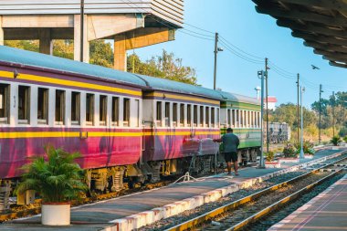 Erkek hademe, trenin dışını temizleyip yıkıyor. Tren istasyonunda treni temizleyen işçiler planlanan kalkıştan önce. Turist tatili için temizlik personeli temizlik treni.