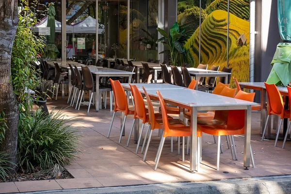 stock image Brisbane, Queensland, Australia - August 2022: Empty tables and chairs of an outdoor restaurant not yet open for service.