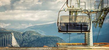 gondola ski lift in mountain ski resort, green forest. Alps. Italy clipart