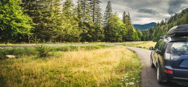 Dağ yolunda seyahat etmek için bir araba. Mavi gökyüzü