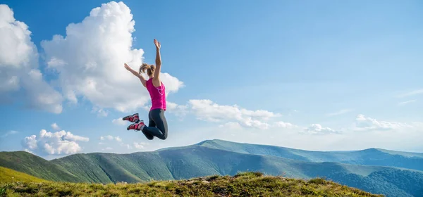 stock image Young woman jumping on the top of mountains