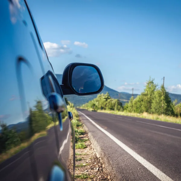 Car Traveling Mountain Road Blue Sky — стоковое фото