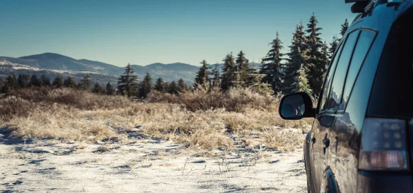 stock image car for traveling with a winter mountain road. Blue sky