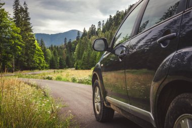 Woman in white bathrobe lying on sofa and relaxing with orange cocktail at the roof of hotel