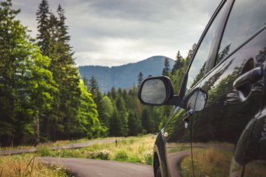 Woman in white bathrobe lying on sofa and relaxing with orange cocktail at the roof of hotel
