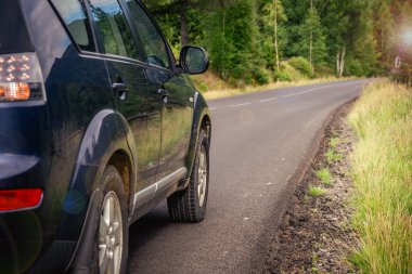 car for traveling with a mountain road. Dramatic sky